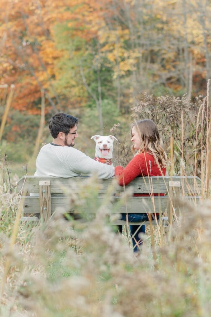 couple posing with their pet dog